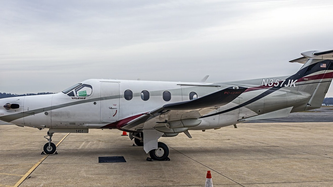 A single-engine turboprop utility aircraft of the nine-passenger class parked on an apron, of the type certified to operate from short unpaved strips.